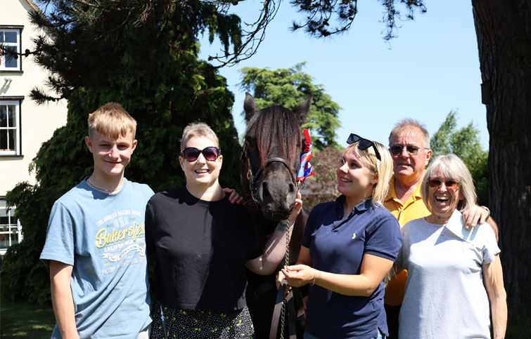 Image: Victoria with her family and gelding fell pony in the hospice garden