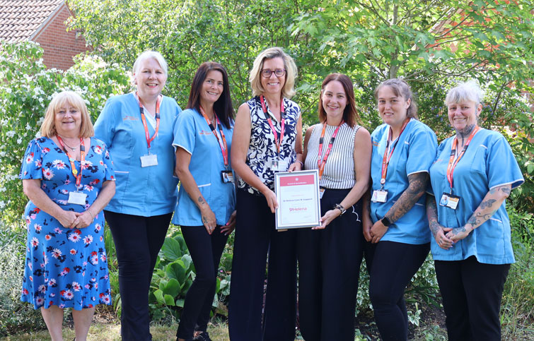 Care & Support staff being awarded care home accreditation award