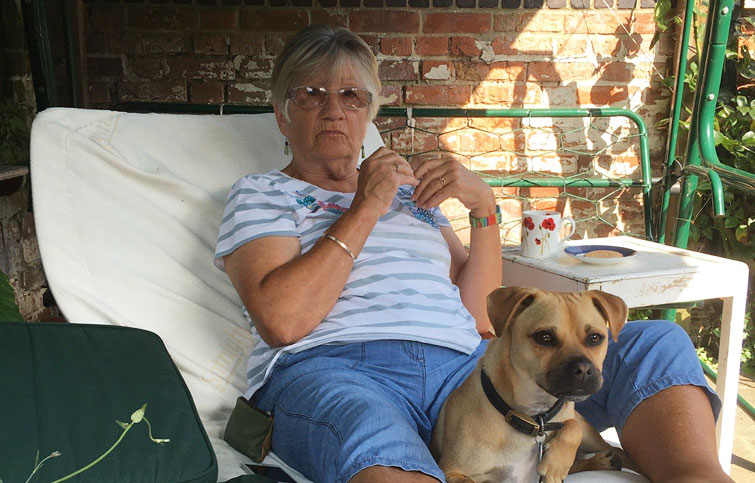 Image: Julie who died at St Helena Hospice three weeks after colon cancer diagnosis, pictured with her dog in the garden